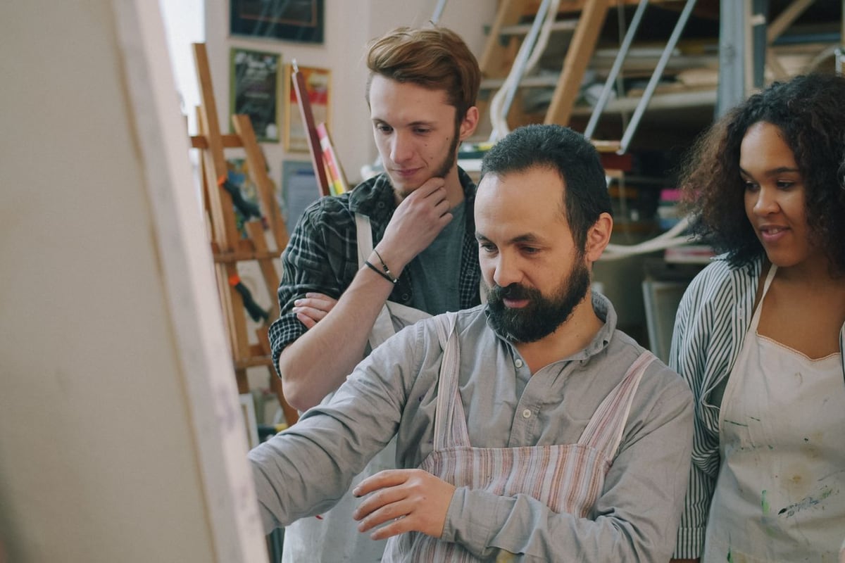 Creative professional guiding adults in a hands-on workshop